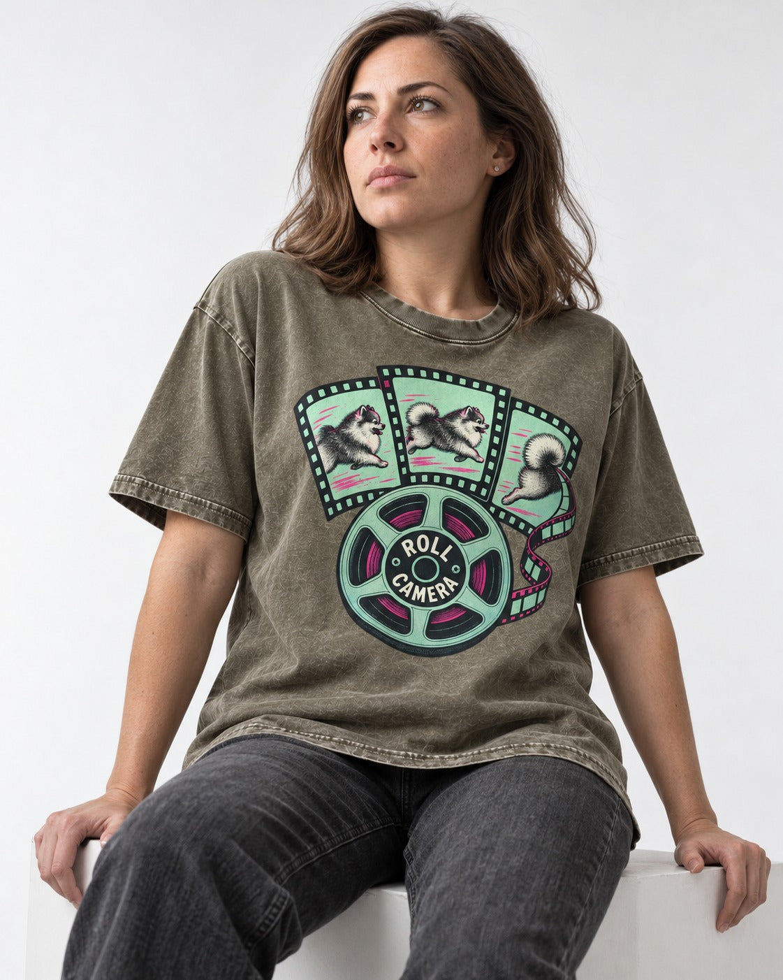 Pomeranian Roll Camera Film Reel Graphic Washed Tee in Army Green, worn by a seated model
