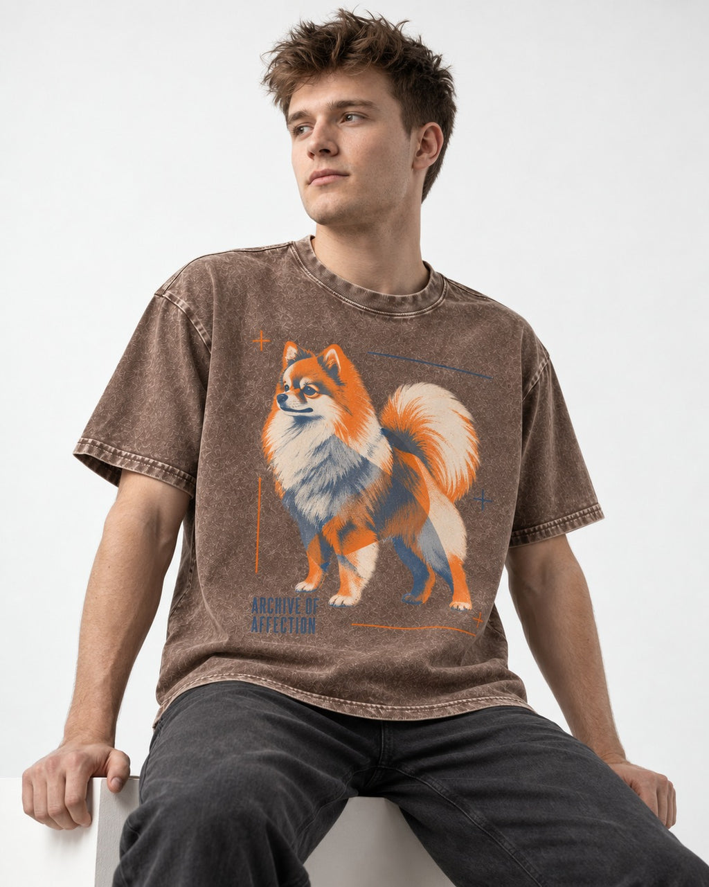 Pomeranian Archive of Affection Washed Tee in Coffee, worn by a seated model