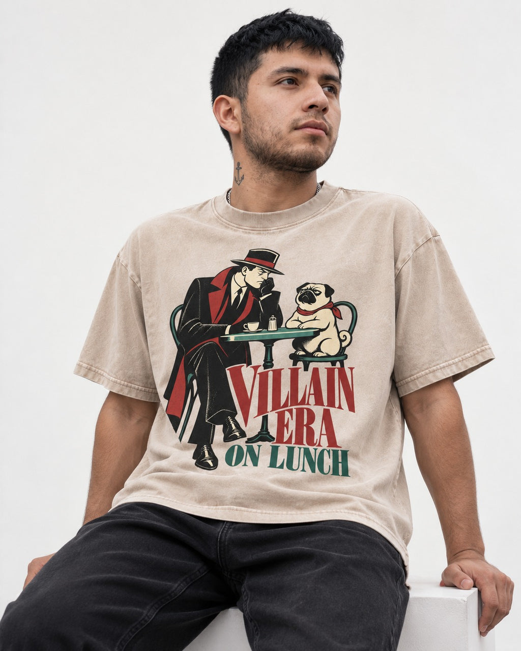 Pug Villain Era Washed Tee in Apricot, worn by a seated model