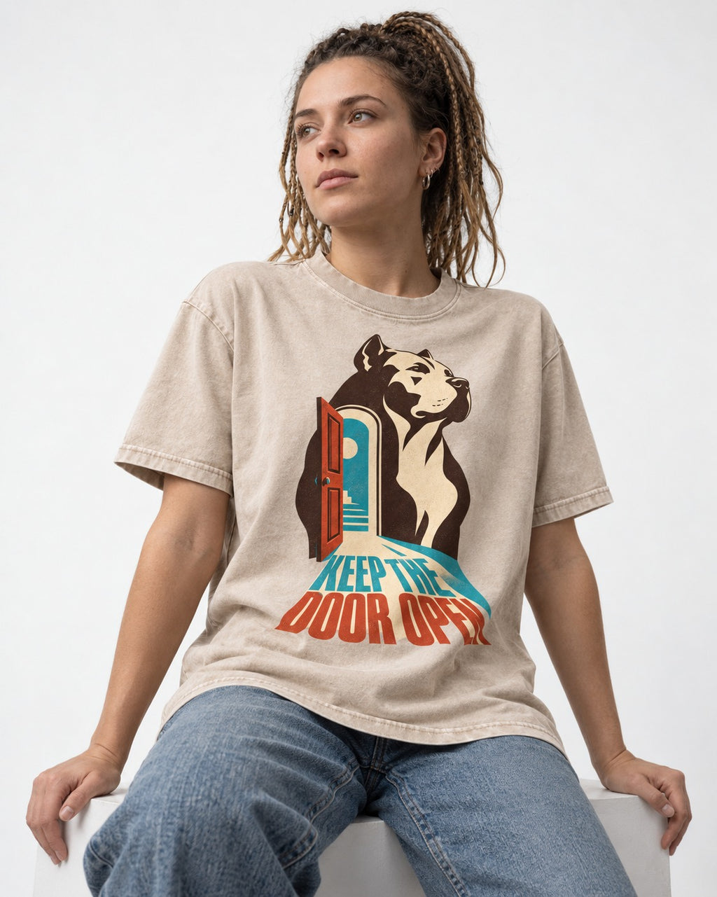 Keep the Door Open Pitbull Washed Tee in Apricot, worn by a seated model
