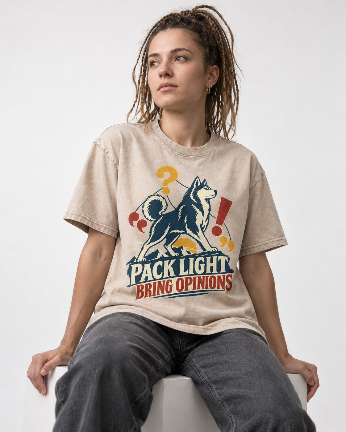 Husky Pack Light Bring Opinions Washed Tee in Apricot, worn by a seated model