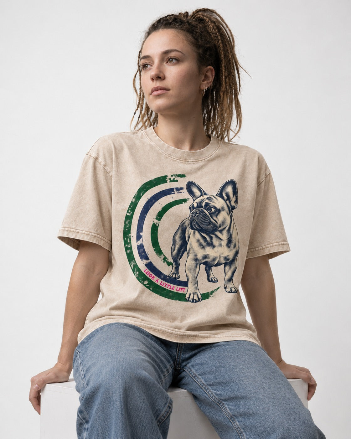 Frenchie Look a Little Left Orbit Graphic Washed Tee in Apricot, worn by a seated model