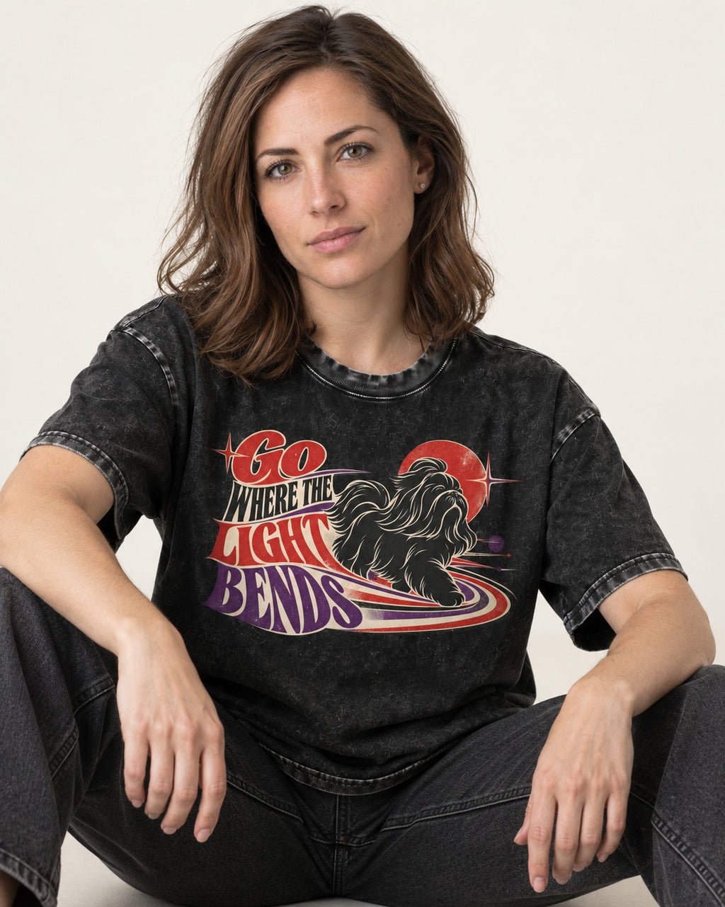 Shih Tzu Go Where the Light Bends Cosmic Orbit Graphic Washed Tee in Black, worn by a seated model