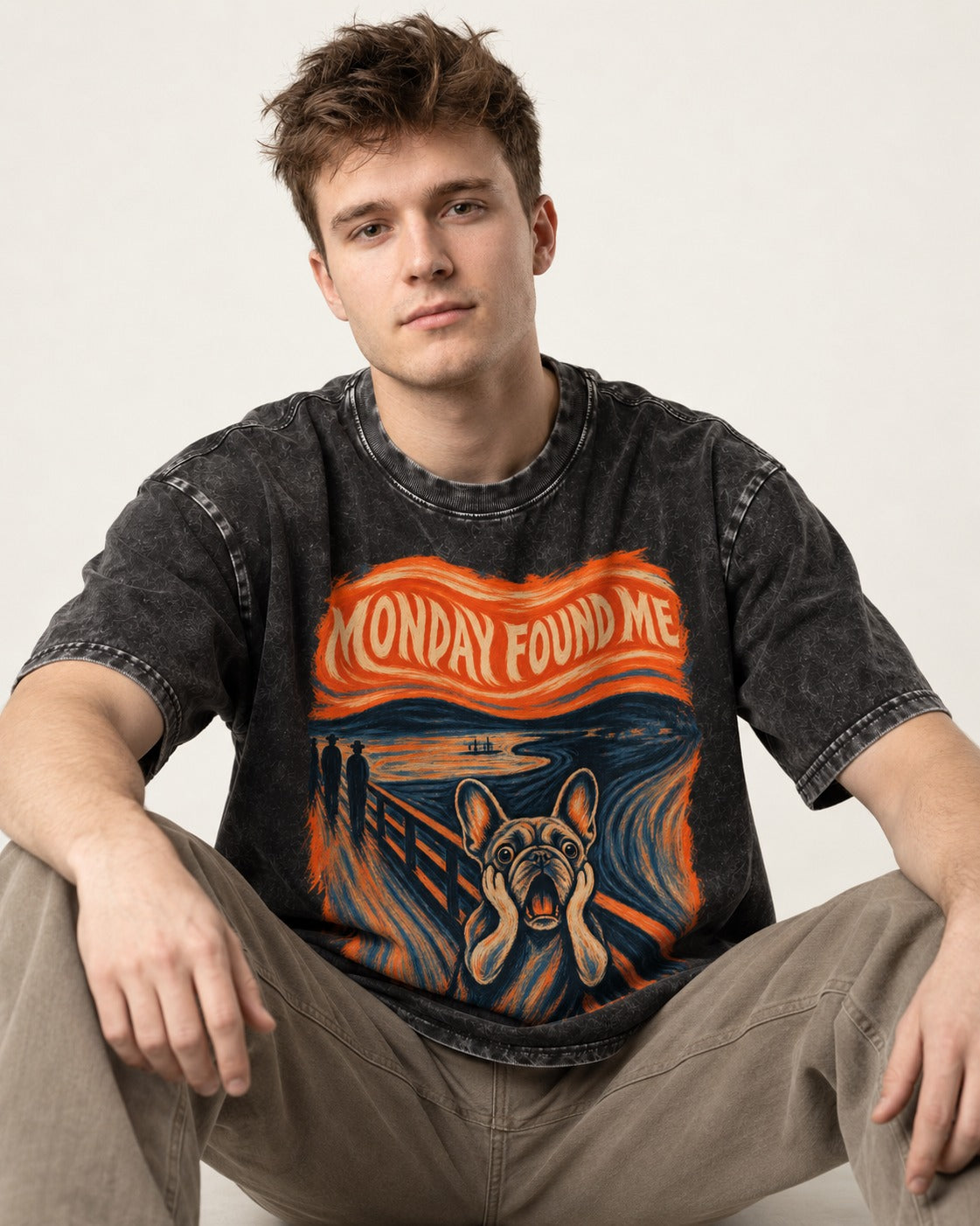 Frenchie Monday Found Me Scream Graphic 194 Washed Tee in Black, worn by a seated model