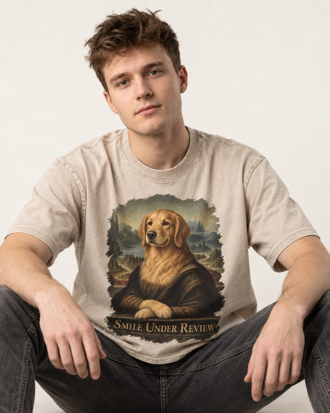Smile Under Review Renaissance Portrait Golden Retriever Graphic Washed Tee in Apricot, worn by a seated model