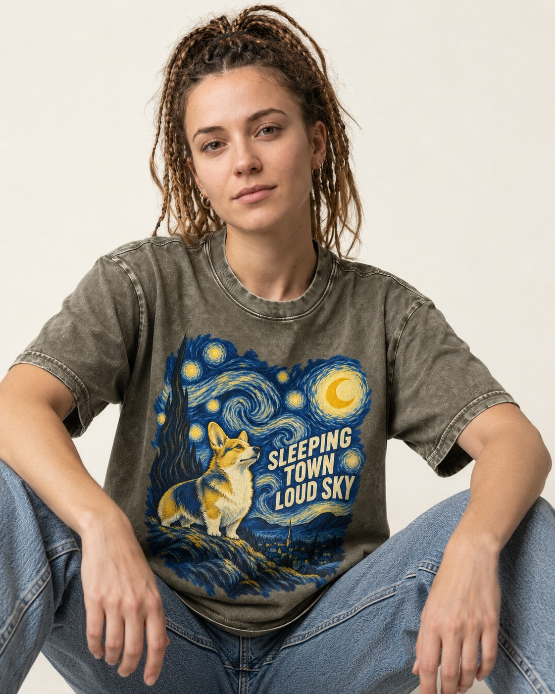 Corgi Sleeping Town Loud Sky Starry Night Washed Tee in Army Green, worn by a seated model