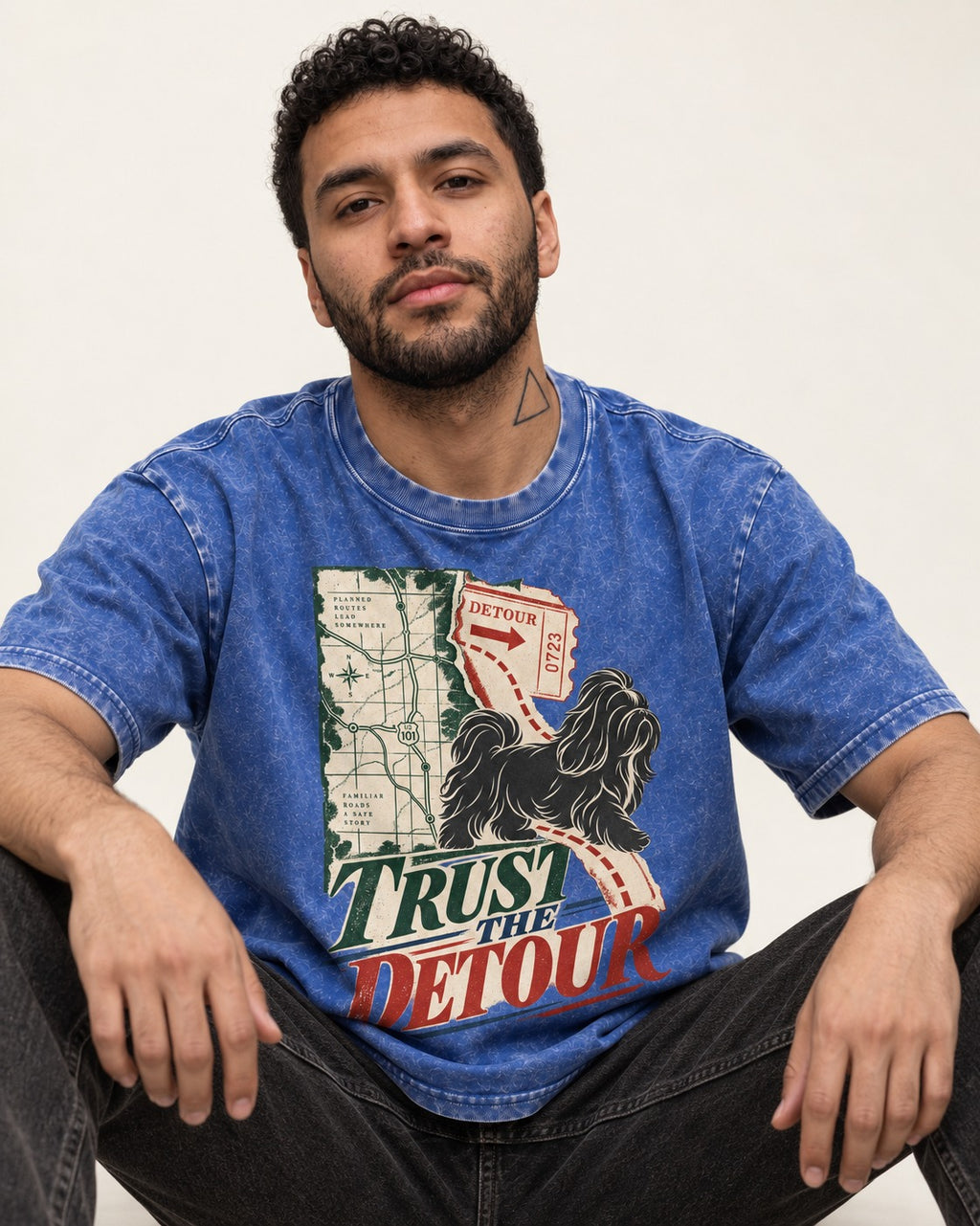 Shih Tzu Trust the Detour Road Map Graphic Washed Tee in Royal Blue, worn by a seated model
