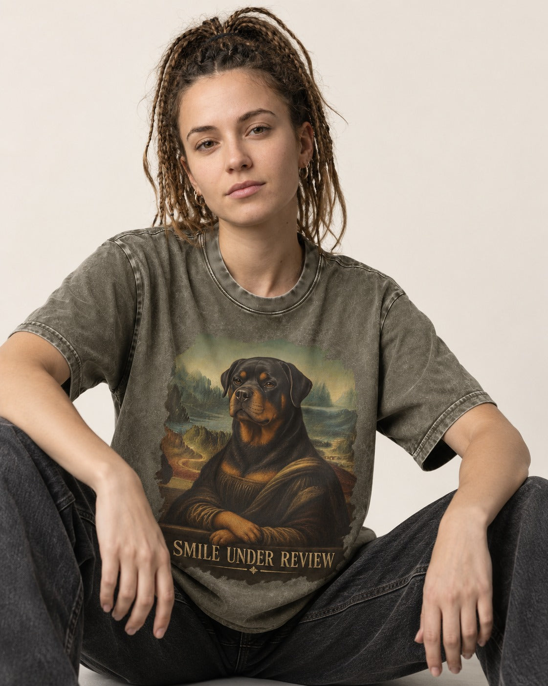 Rottweiler Smile Under Review Renaissance Portrait Graphic Washed Tee in Army Green, worn by a seated model
