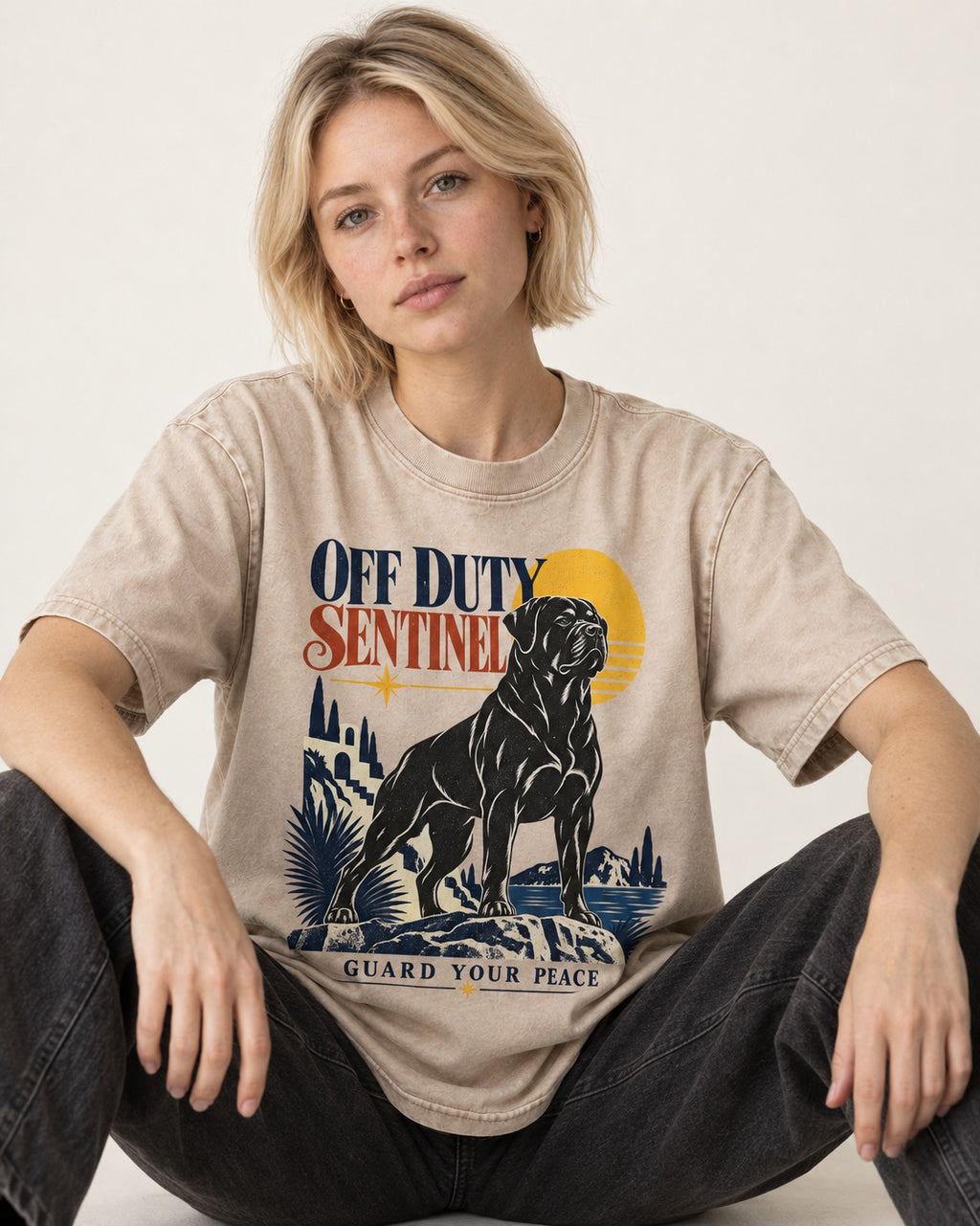 Off Duty Rottweiler Sentinel Washed Tee in Apricot, worn by a seated model