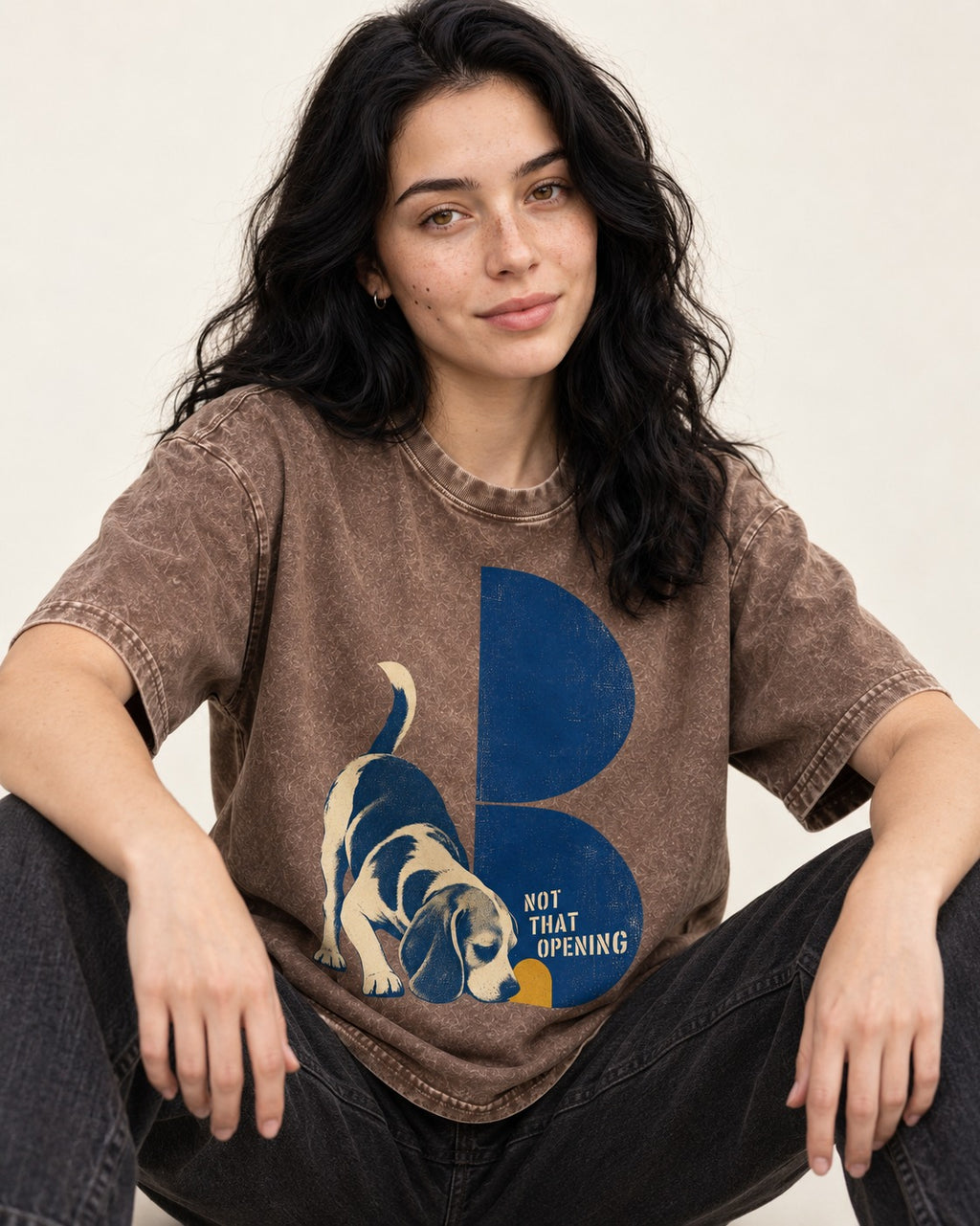Not That Opening Beagle Washed Tee in Coffee, worn by a seated model
