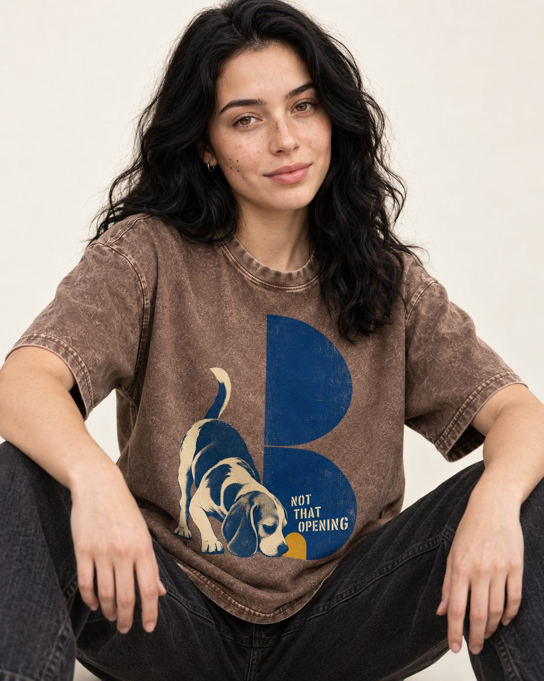 Not That Opening Beagle Washed Tee in Coffee, worn by a seated model