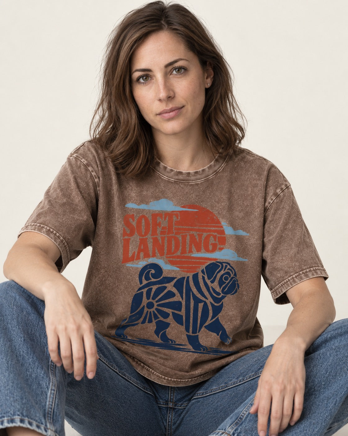 Pug's Soft Landing Washed Tee in Coffee, worn by a seated model