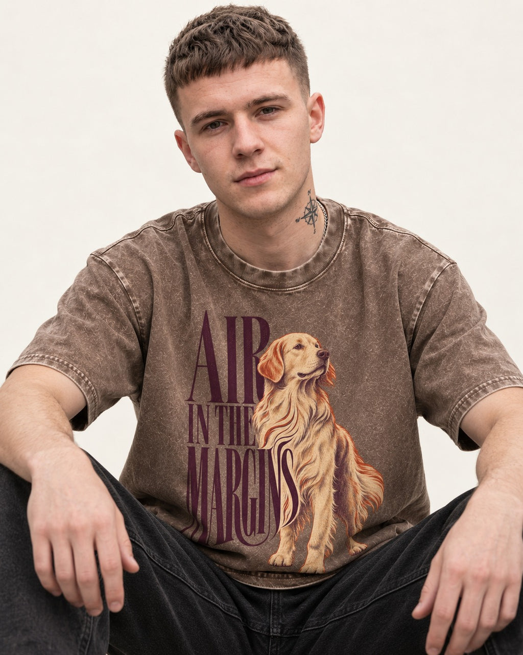 Golden Retriever In the Margins Washed Tee in Coffee, worn by a seated model