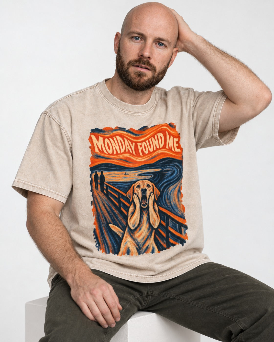 Labrador Retriever Monday Found Me Scream Parody Graphic Washed Tee in Apricot, worn by a seated model