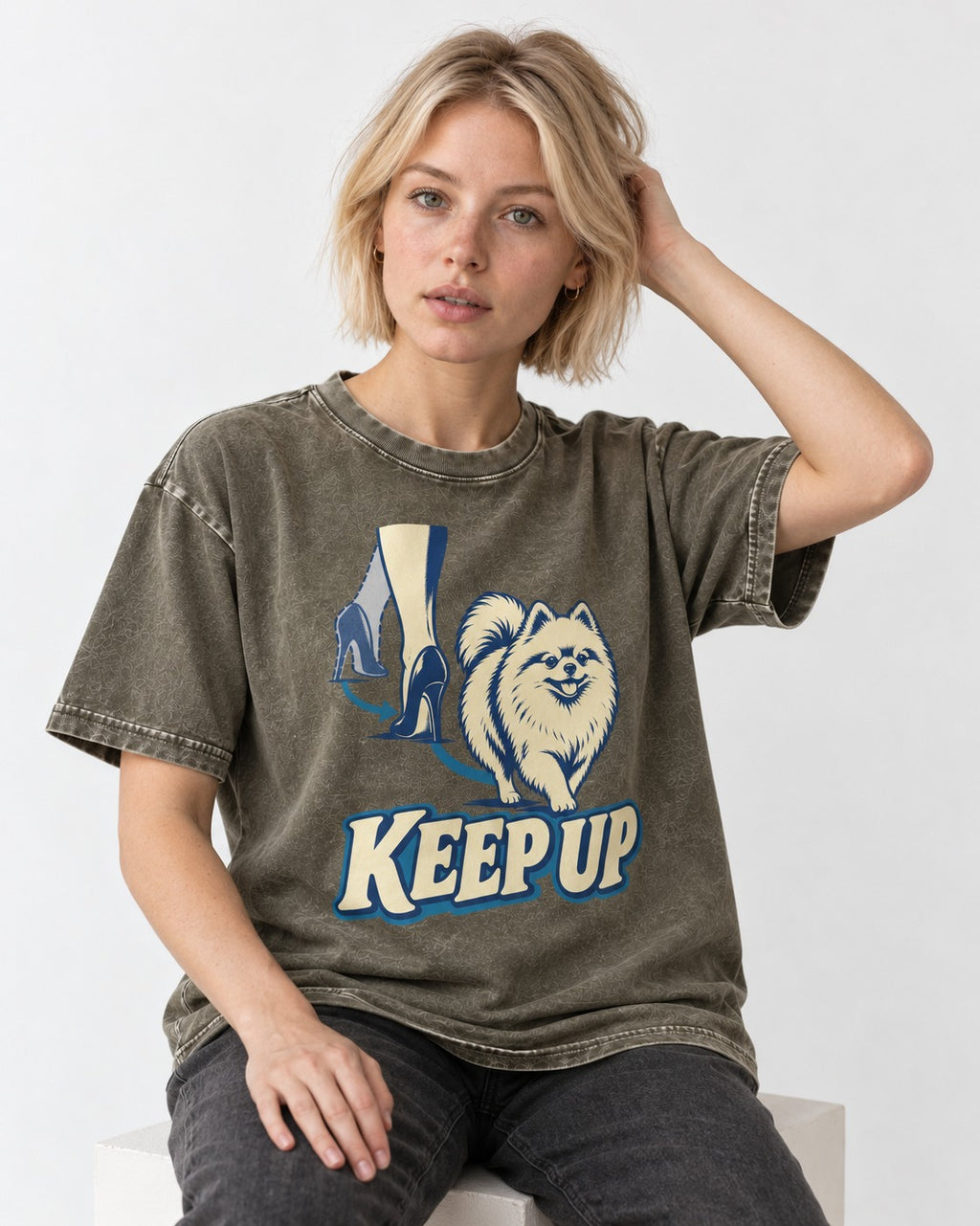 Pomeranian Keep Up High Heel Chase Graphic Washed Tee in Army Green, worn by a seated model