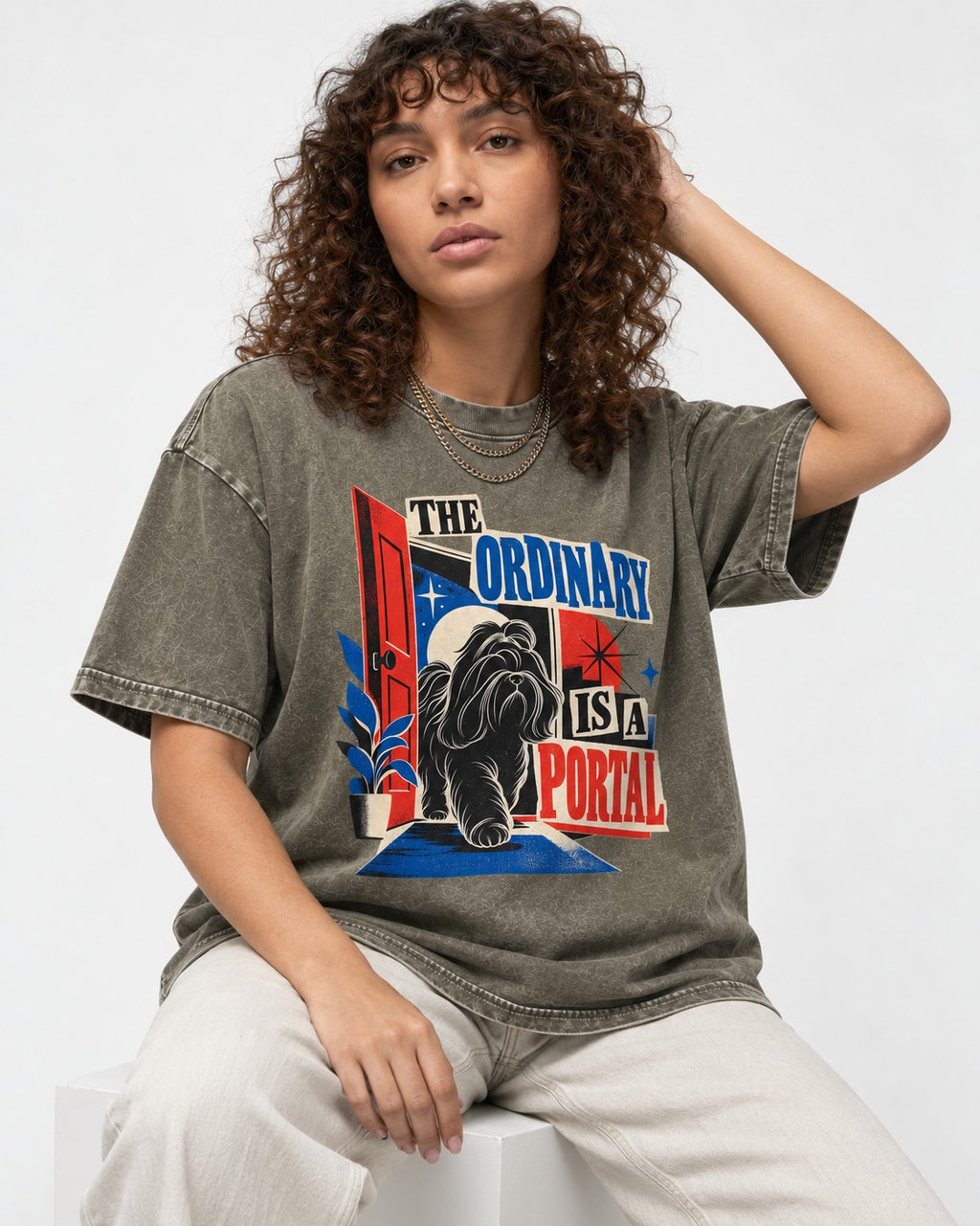 Shih Tzu The Ordinary Is a Portal Door Graphic Washed Tee in Army Green, worn by a seated model