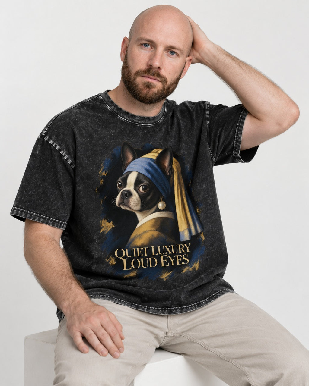 Quiet Luxury Loud Eyes Boston Terrier Pearl Portrait Washed Tee in Black, worn by a seated model
