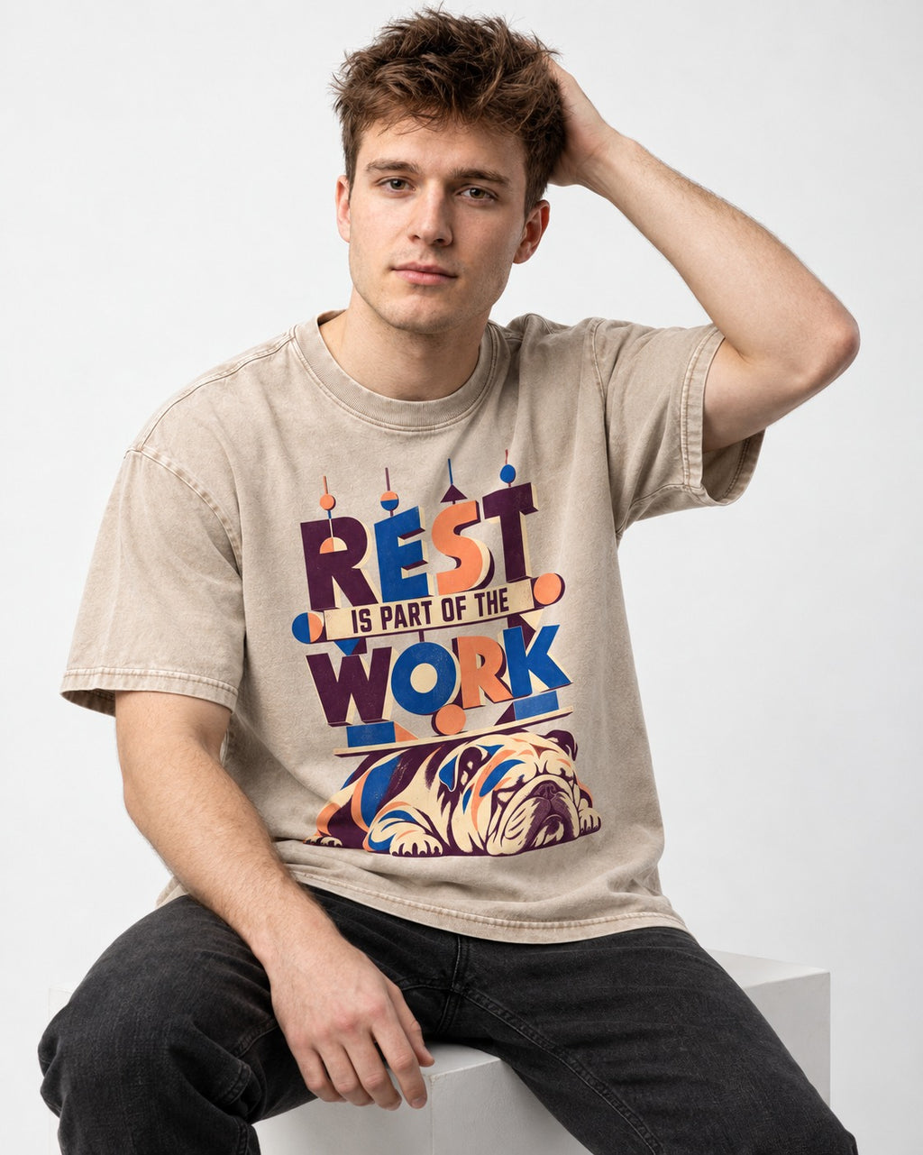 Rest Is Work English Bulldog Washed Tee in Apricot, worn by a seated model