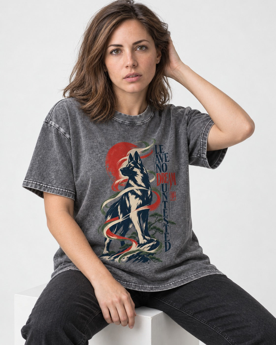 Leave No Dream Untested German Shepherd Dog Washed Tee in Gray, worn by a seated model