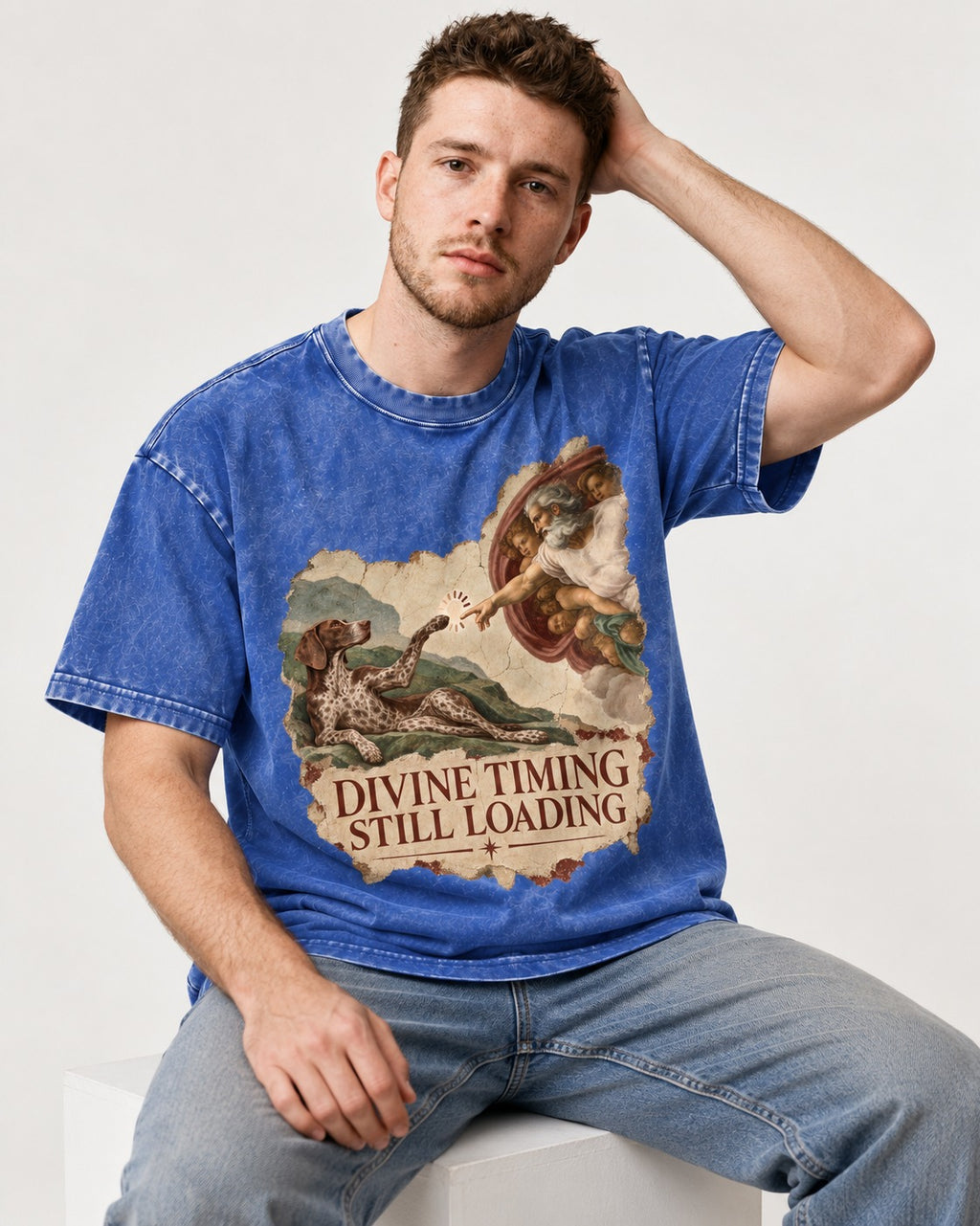 German Shorthaired Pointer Divine Timing Still Loading Creation Scene Graphic Washed Tee in Royal Blue, worn by a seated model