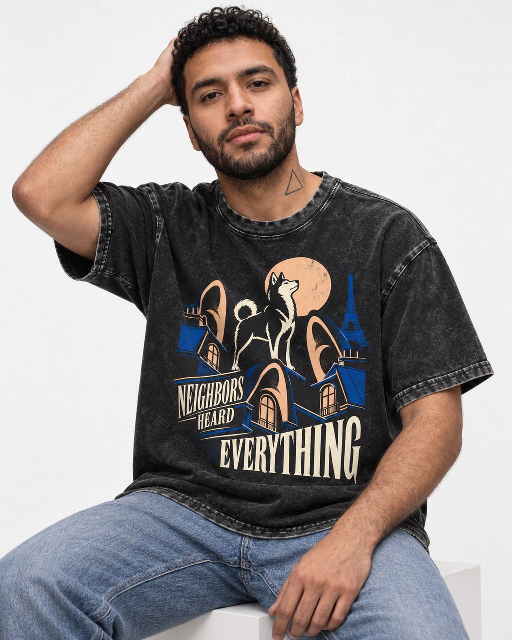 Husky Neighbors Heard Everything Paris Rooftop Graphic Washed Tee in Black, worn by a seated model