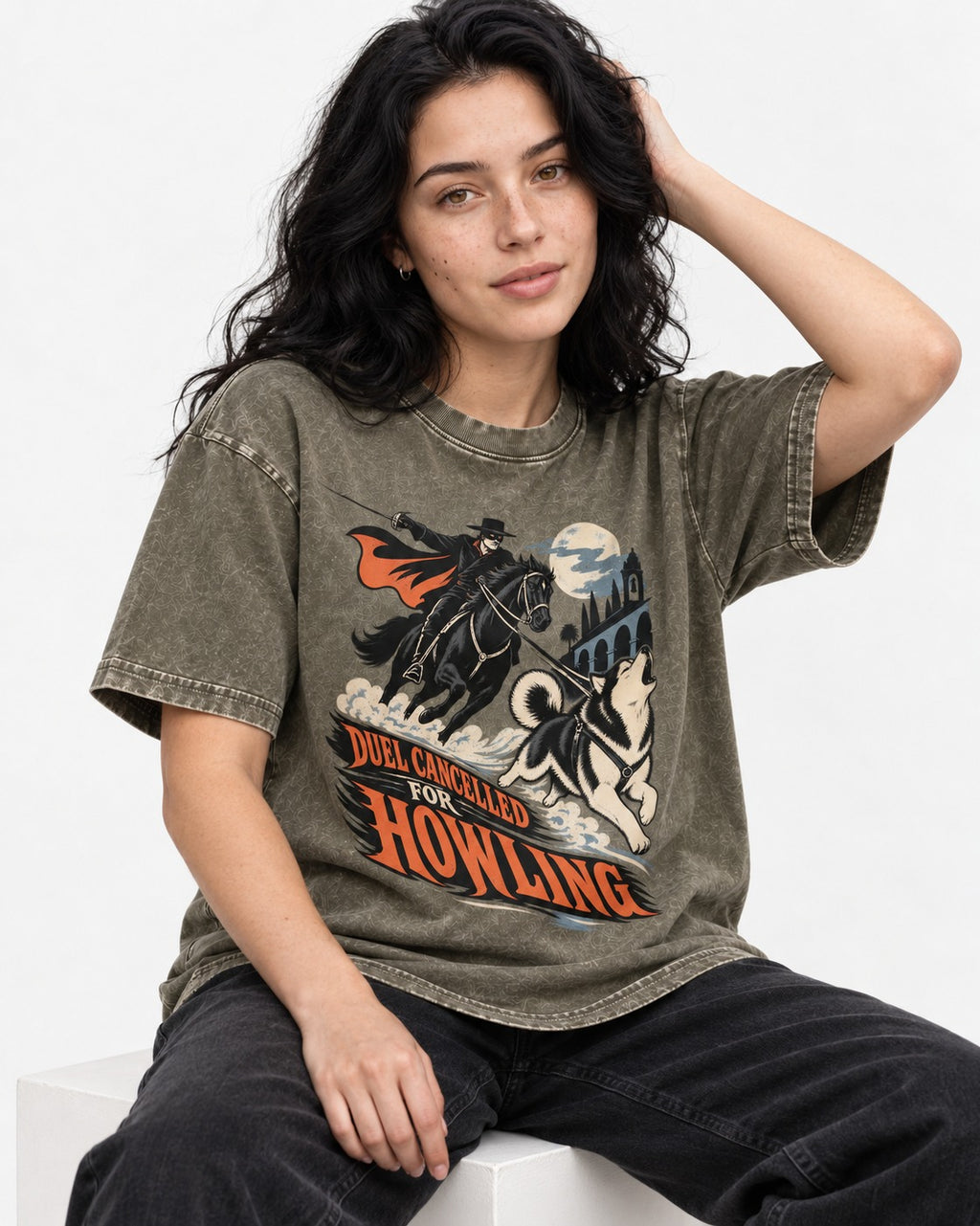 Husky Duel Cancelled for Howling Masked Rider Graphic Washed Tee in Army Green, worn by a seated model