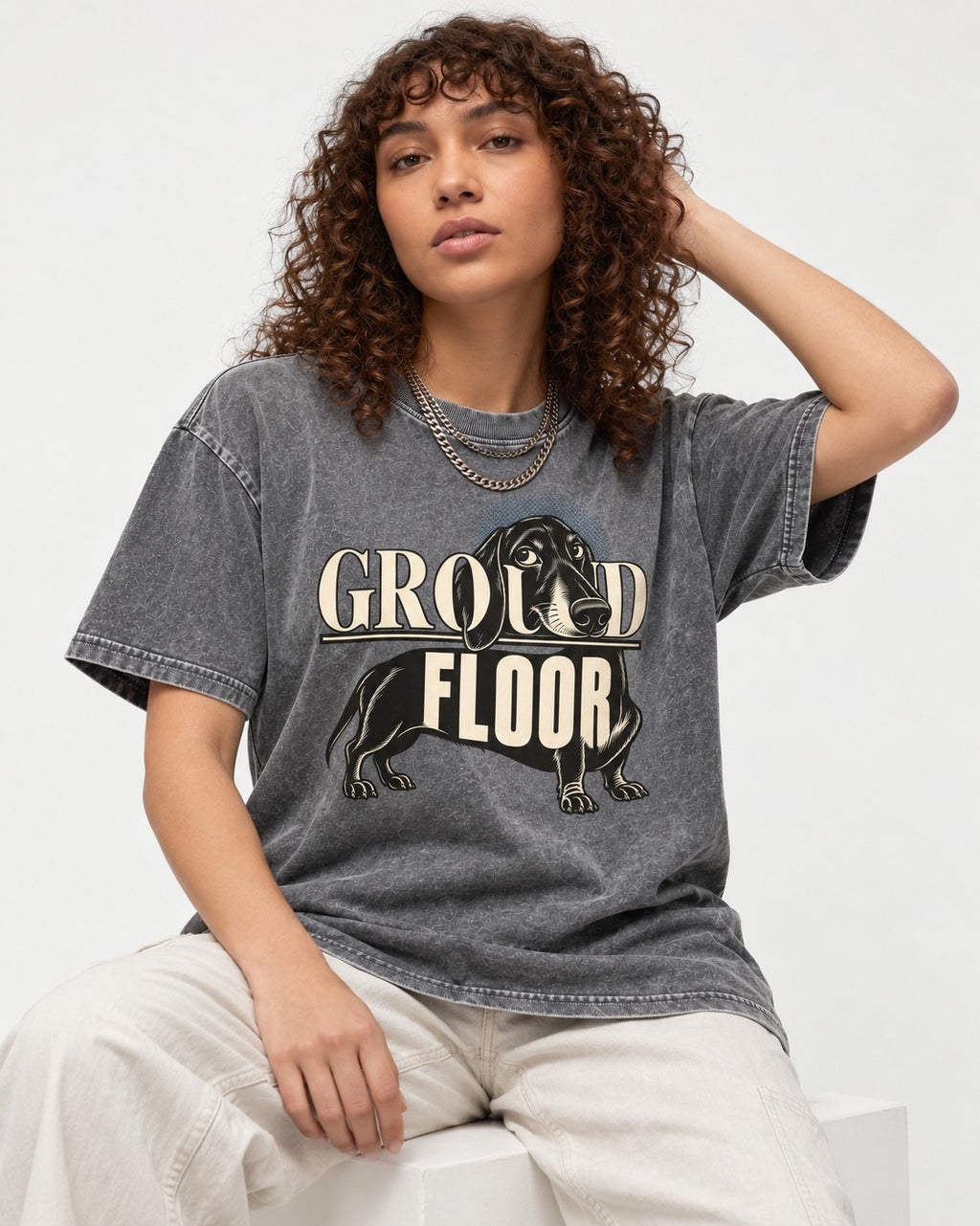 Ground Floor Dachshund Washed Tee in Gray, worn by a seated model
