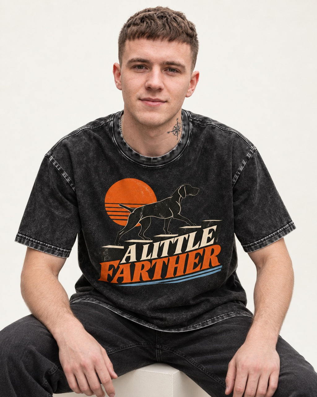 German Shorthaired Pointer A Little Farther Sunset Steps Graphic Washed Tee in Black, worn by a seated model