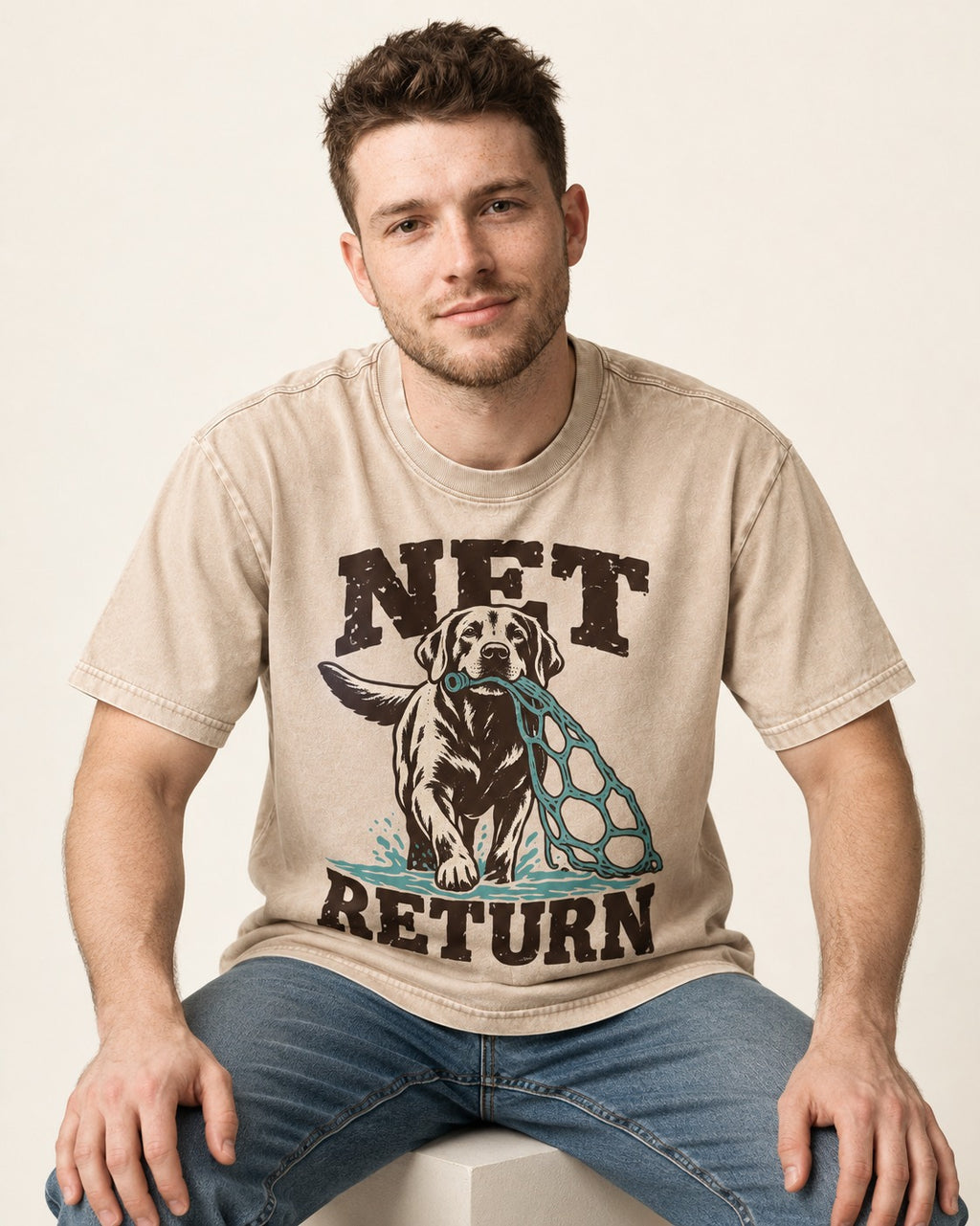 Net Return Labrador Retriever Washed Tee in Apricot, worn by a seated model