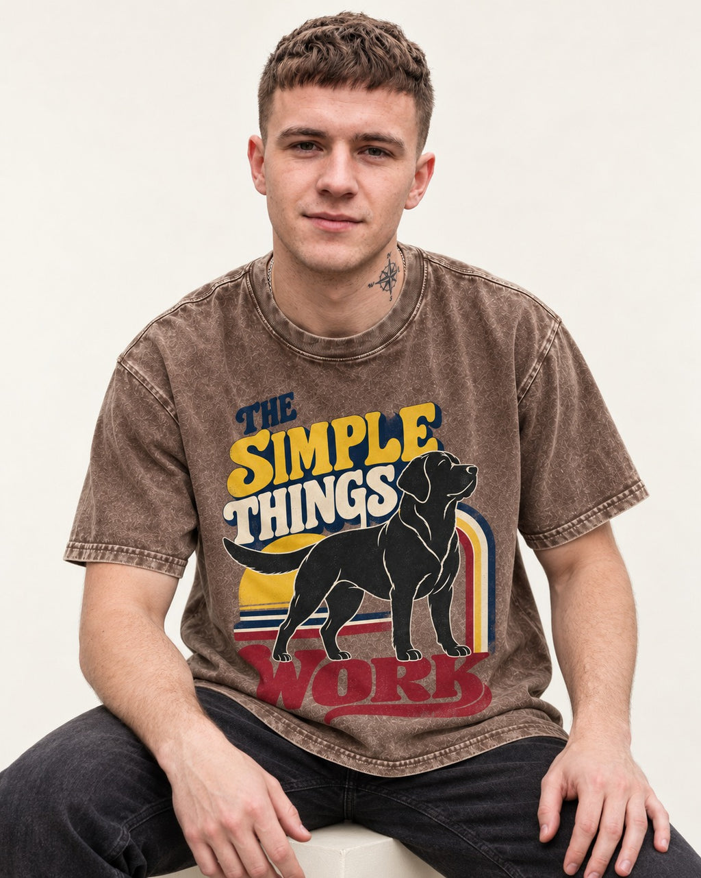 The Simple Things Work Labrador Retriever Washed Tee in Coffee, worn by a seated model