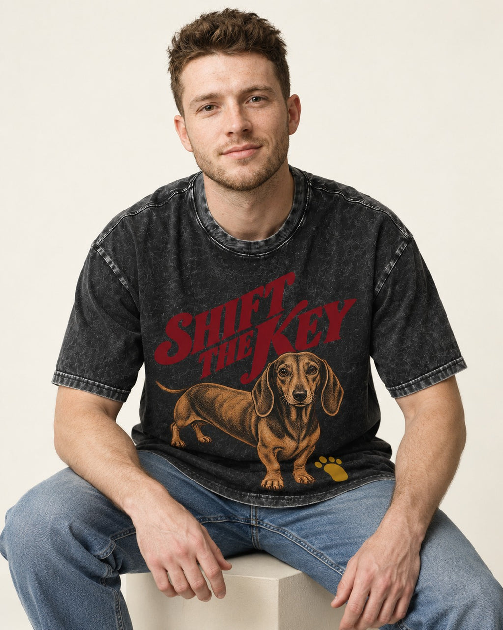 Dachshund Shift The Key Pawprint Graphic Washed Tee in Black, worn by a seated model
