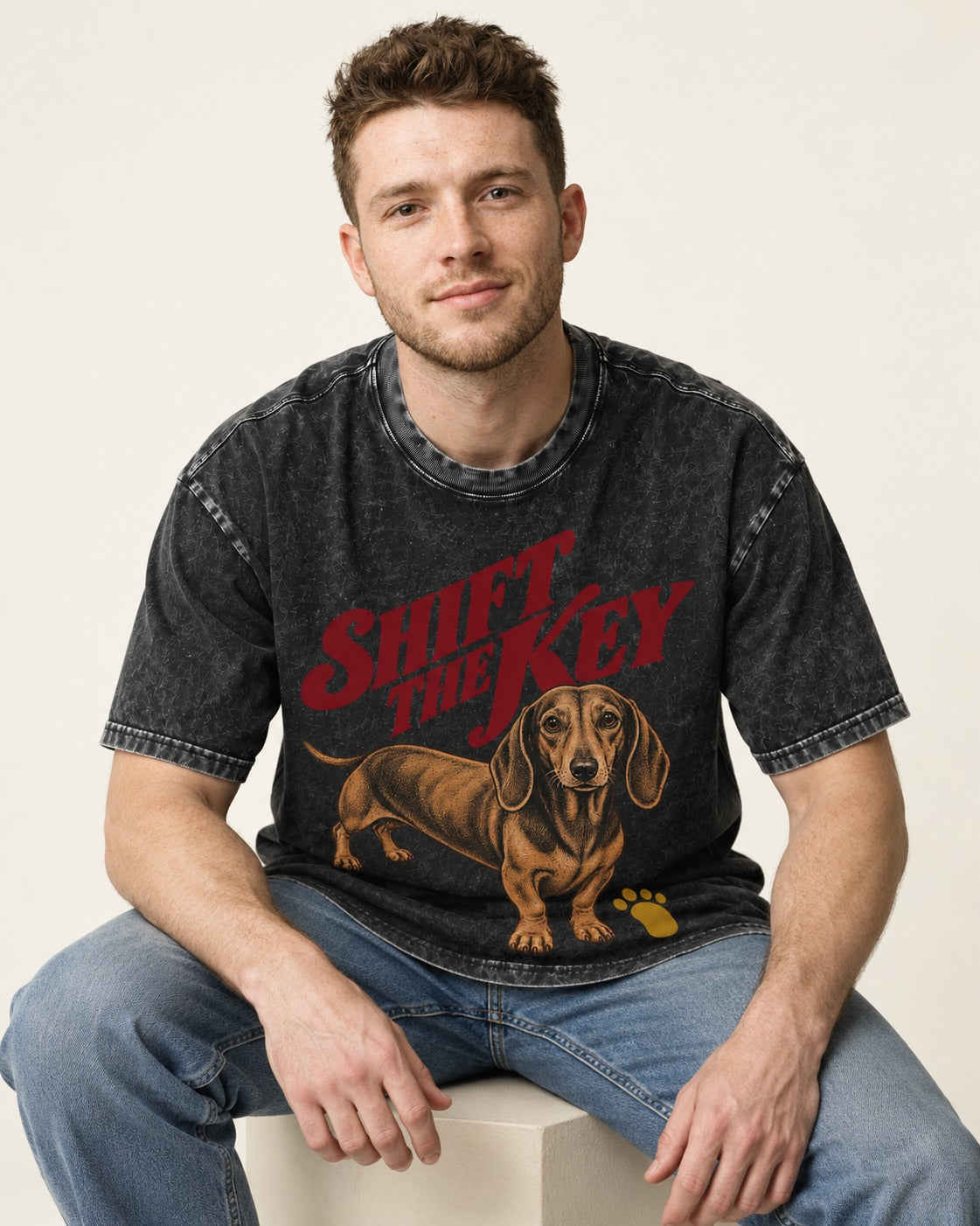 Dachshund Shift The Key Pawprint Graphic Washed Tee in Black, worn by a seated model