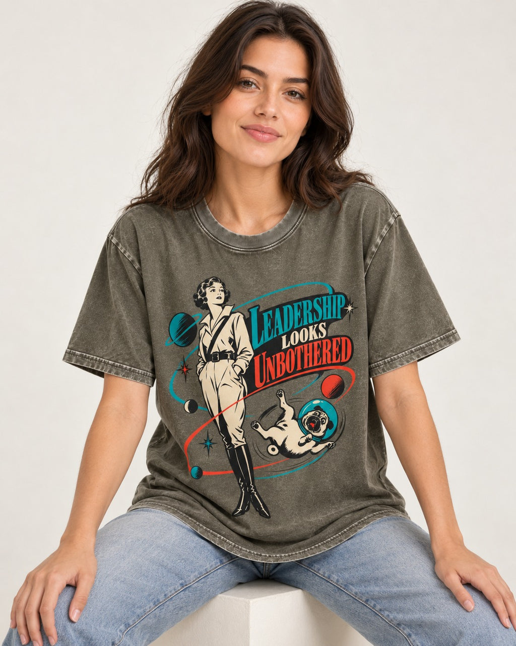 Pug Leadership Looks Unbothered Space Graphic Washed Tee in Army Green, worn by a seated model