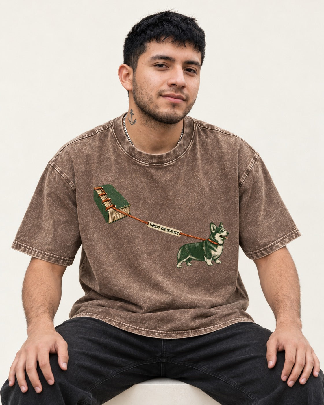 Thread the Distance with Corgi Washed Tee in Coffee, worn by a seated model