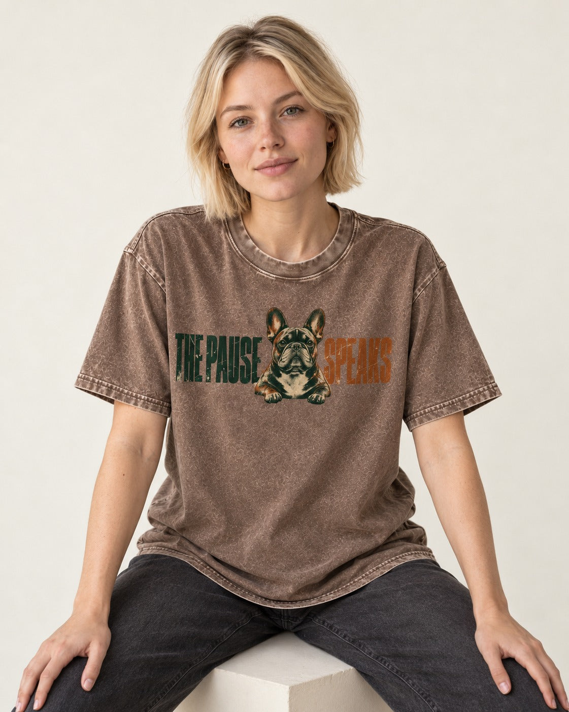 The Frenchie Pause Speaks Washed Tee in Coffee, worn by a seated model