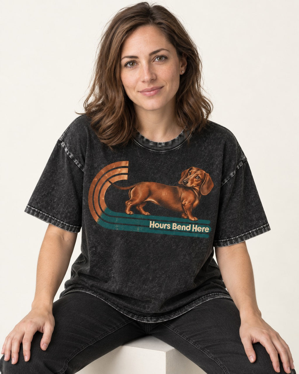 Dachshund Hours Bend Here Retro Track Graphic Washed Tee in Black, worn by a seated model