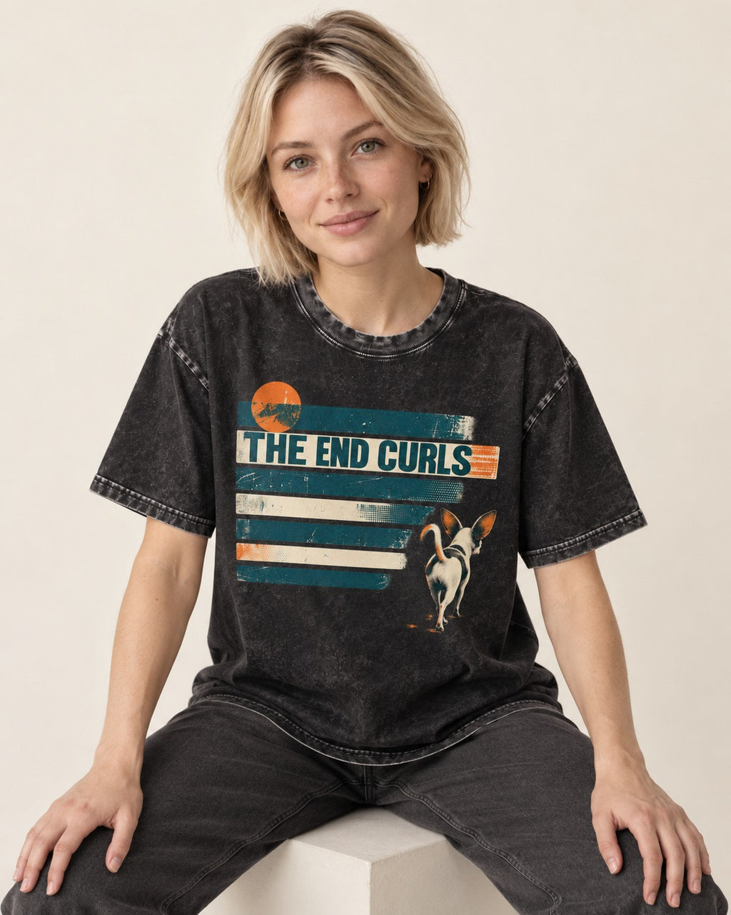 Chihuahua The End Curls Retro Stripe Graphic Washed Tee in Black, worn by a seated model