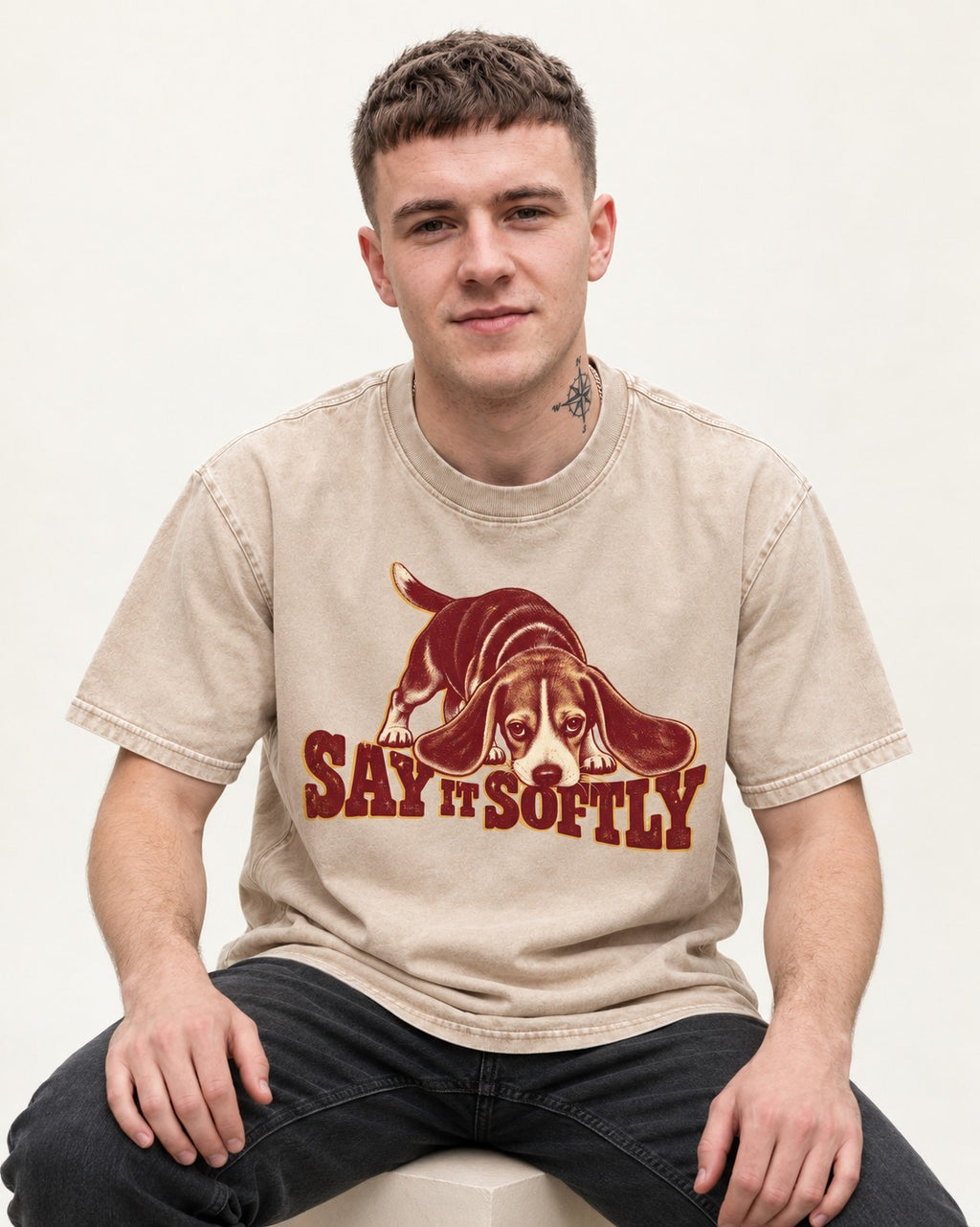 Beagle Say It Softly Washed Tee in Apricot, worn by a seated model