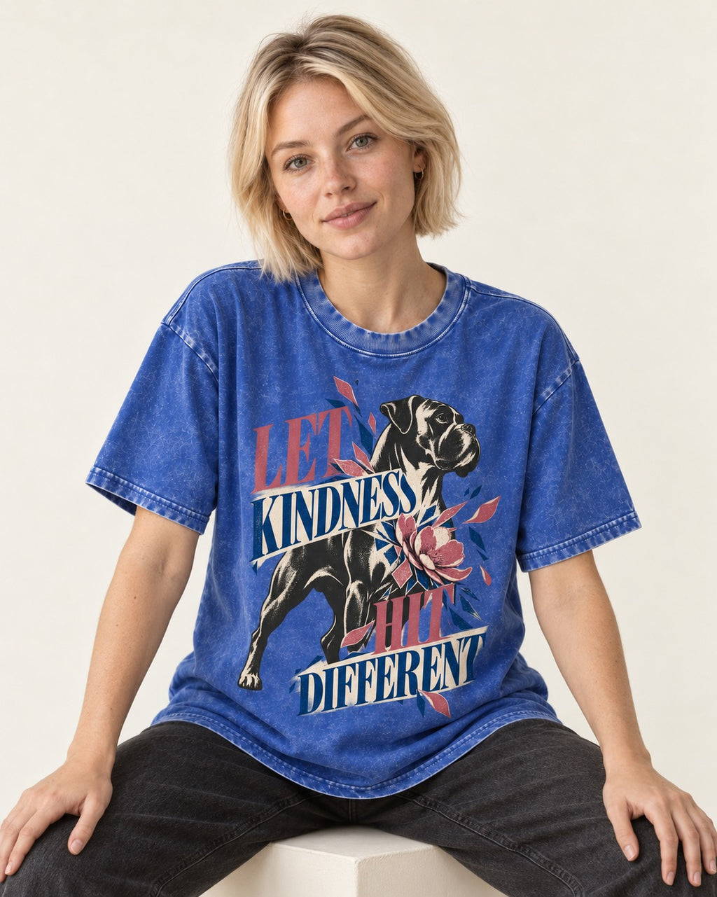 Let Kindness Hit Different Boxer Floral Collage Washed Tee in Royal Blue, worn by a seated model