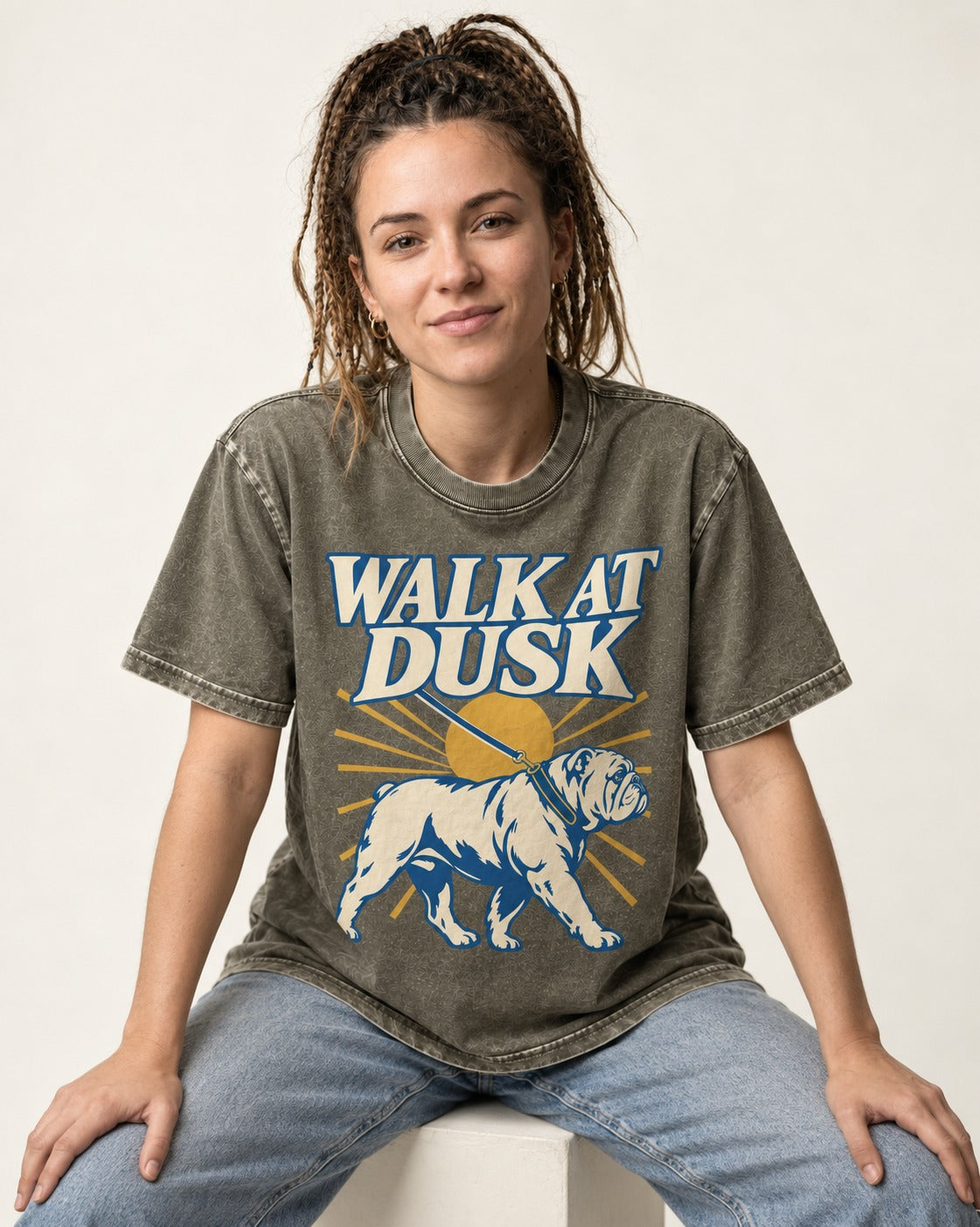 English Bulldog Walk at Dusk Sunset Graphic Washed Tee in Army Green, worn by a seated model