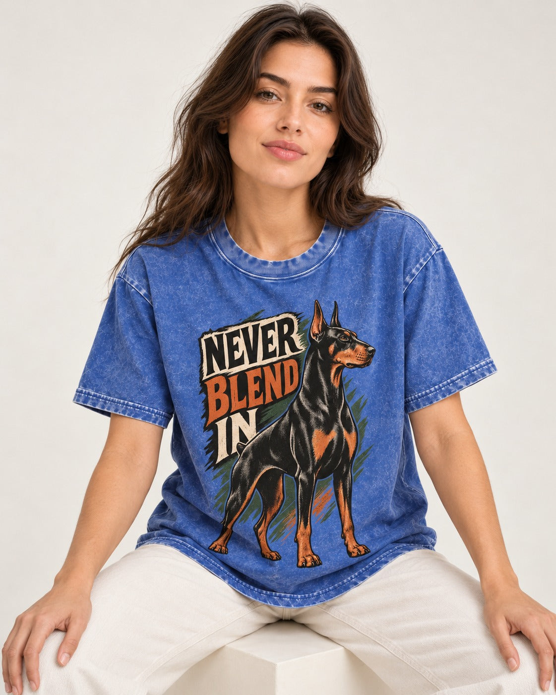 Doberman Never Blend In Brush Graphic Washed Tee in Royal Blue, worn by a seated model