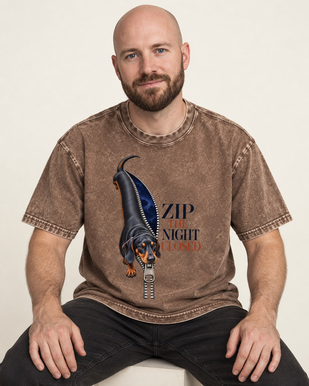Zip the Night Closed Dachshund Washed Tee in Coffee, worn by a seated model