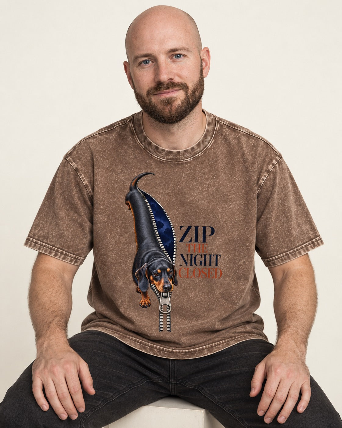 Zip the Night Closed Dachshund Washed Tee in Coffee, worn by a seated model