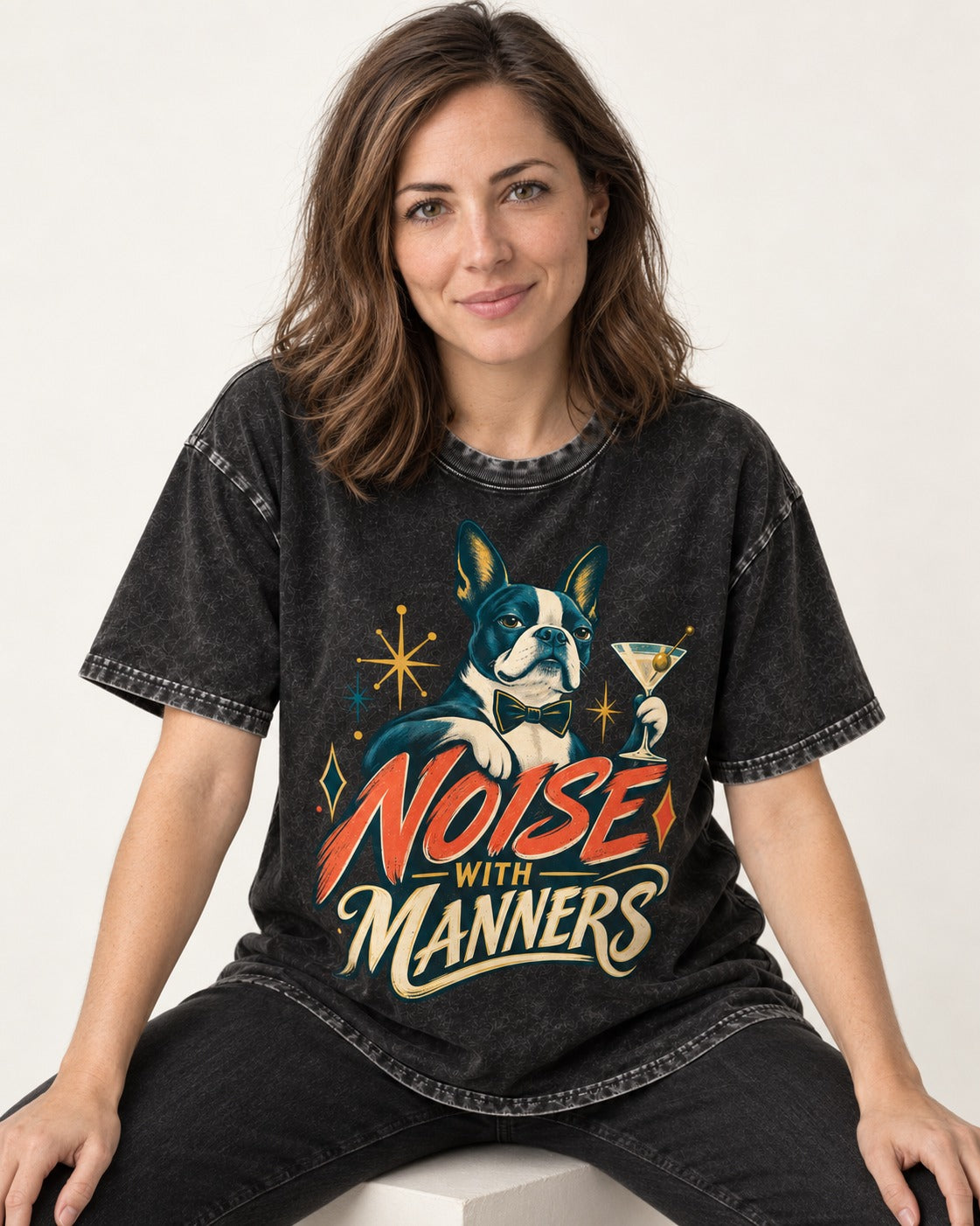 Boston Terrier Noise With Manners Cocktail Graphic Washed Tee in Black, worn by a seated model