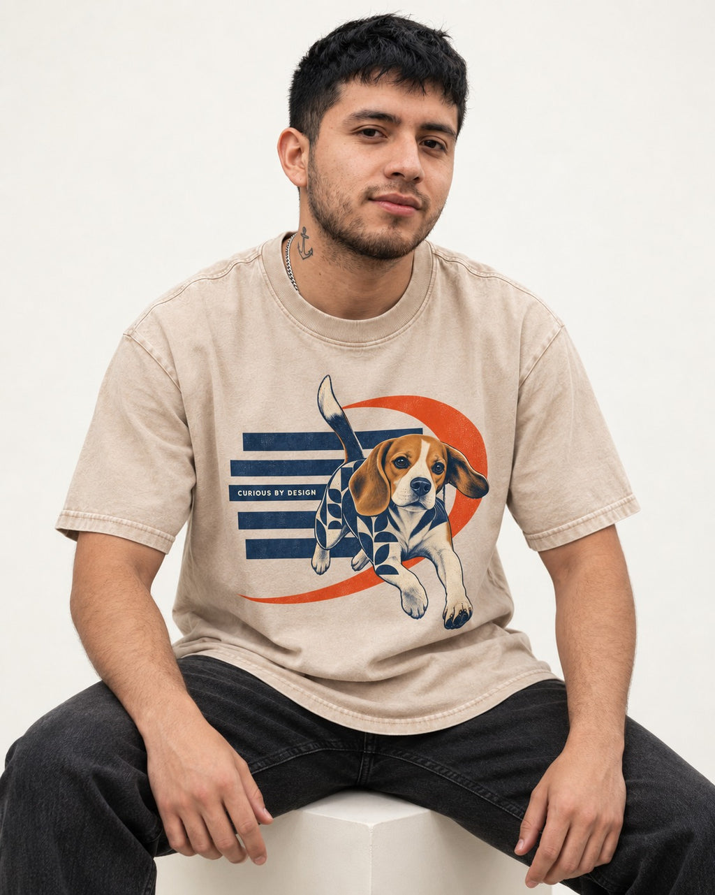 Beagle Born Curious Washed Tee in Apricot, worn by a seated model