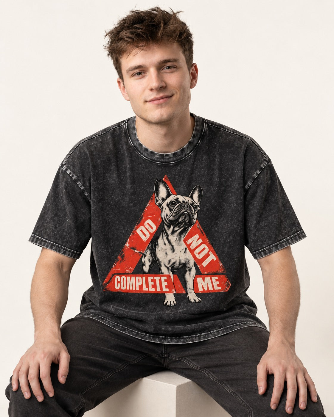 Frenchie Do Not Complete Me Warning Triangle Graphic Washed Tee in Black, worn by a seated model