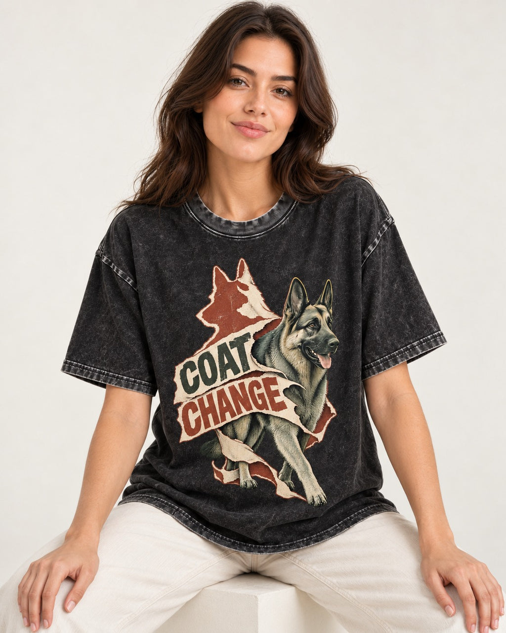 Coat Change Running German Shepherd Dog Ribbon Graphic Washed Tee in Black, worn by a seated model