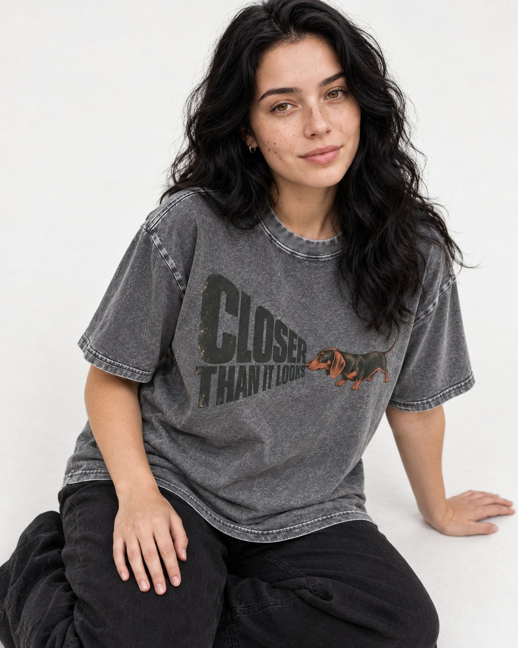 Dachshund Closer Than It Looks Washed Tee in Gray, worn by a seated model