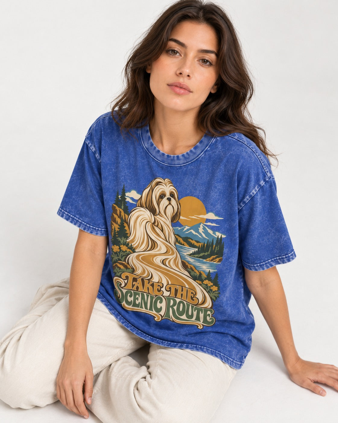 Shih Tzu Take the Scenic Route Mountain Vista Graphic Washed Tee in Royal Blue, worn by a seated model