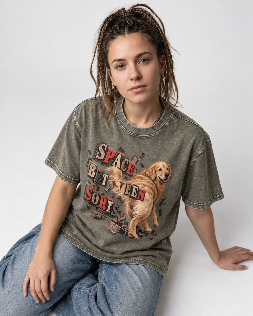 Golden Retriever Space Between Sorts Letterpress Graphic Washed Tee in Army Green, worn by a seated model